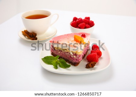 Biscuit cake with fresh berries on white background.