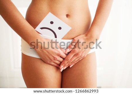 Woman Health. Female Body Holding Sad Smile Card Near Stomach.
