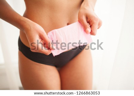 Closeup Of Beautiful Woman Body In Underwear Holding Panty Liner.