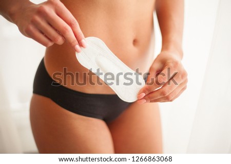 Closeup Of Beautiful Woman Body In Underwear Holding Panty Liner.