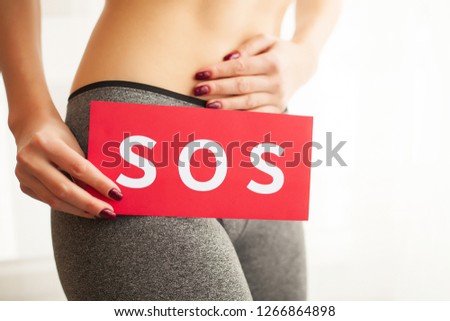 Woman Health. Female Body Holding Symbol Help Card Near Stomach.