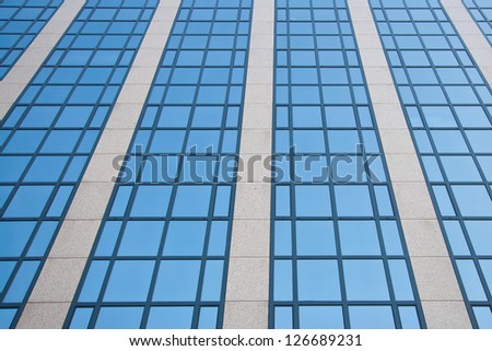 blue sky reflected in grid formed by windows