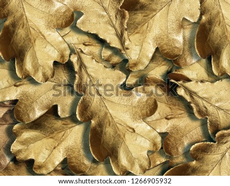 shiny gold oak leaves texture background. close up.
