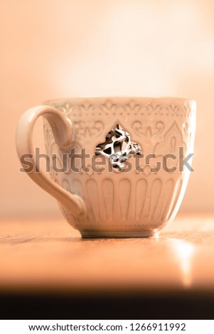A picture of a coffee cup with cogs visible in side