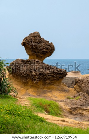 Unique geological formations at Yehliu Geopark in Taiwan on a sunny day with a blue sky with some clouds