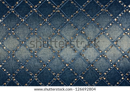 Light-blue denim with yellow and silver rhinestones, background Royalty-Free Stock Photo #126692804