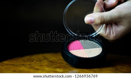 Various makeup products on dark background 