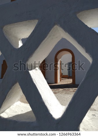 Structure of white masonry with triangular shape.