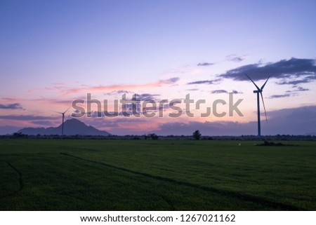 Wind turbine farm or windmill on a summer day. High-quality stock photo image wind turbine or windmill in a green field - Energy Production with clean and Renewable Energy. Phan Rang, Vietnam