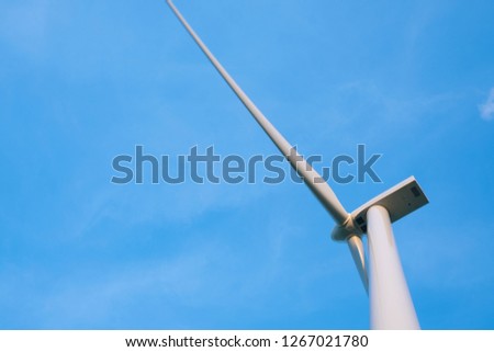 Wind turbine farm, windmill on a summer day. High-quality stock photo image wind turbine or windmill in a green field - Energy Production with clean and renewable energy, clean energy concept