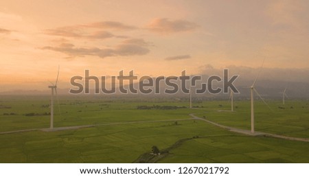 Wind turbine farm, windmill on a summer day. High-quality stock photo image wind turbine or windmill in a green field - Energy Production with clean and renewable energy, clean energy concept