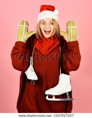 Woman enjoy winter. Sports activity in winter time. Healthy lifestyle. Happy beautiful girl in winter clothes with ice skates. Ice skating woman holds skates. Winter ice skating girl with ice skates.