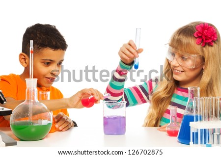 Kids experimenting with chemistry in the school chemistry laboratory class