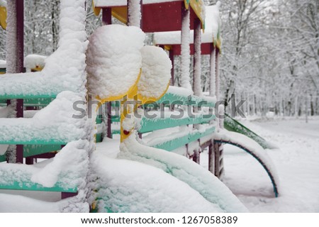 yellow horse in the snow on the playground 