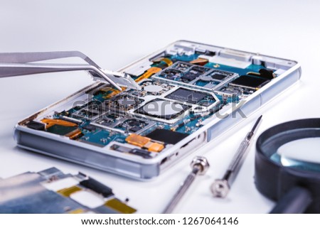Repair smartphone. Smartphone and tools for repairing on grey surface. Royalty-Free Stock Photo #1267064146