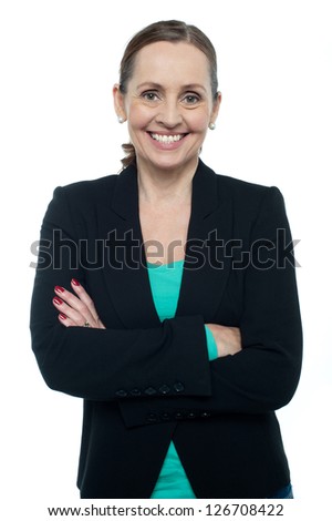 Profile shot of a cheerful confident woman posing with arms crossed.