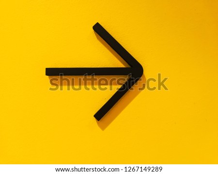Arrow symbol on a yellow background