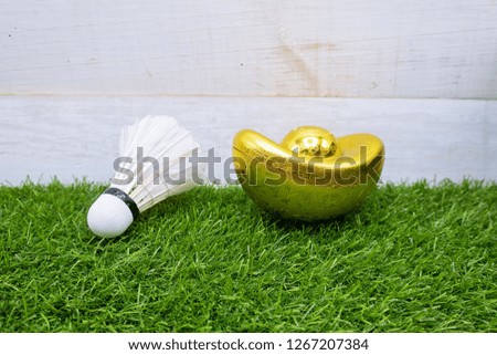 Happy Chinese New Year to Badminton player with shuttlecock and ingot