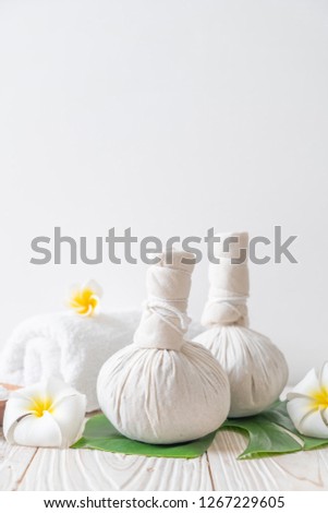 Spa herbal compressing ball with candle and orchid - beauty concept Royalty-Free Stock Photo #1267229605