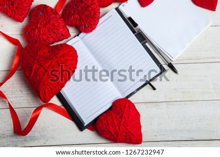 Greeting card with a red hearts and space for text on a wooden background. Love concept.Valentines day