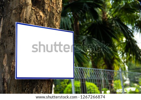 White orientation blank billboard hanging on the tree in park
