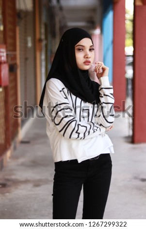 Half body portrait shot of women wearing hijab. Modest street style. Women wearing white top. Fashion inspiration.
