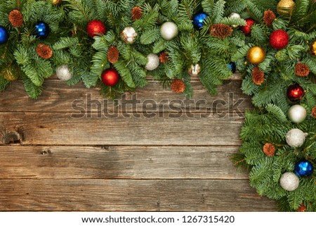 Festive composition of Christmas decorations on wooden background. Flat lay with copy space. New year holiday frame.