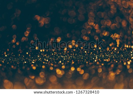 Blur neon gold and blue light circle background. Sparkling firework bokeh dots in vintage style. Luxury and classy new year and christmas celebration party textured dark backdrop. Blurry golden dust.