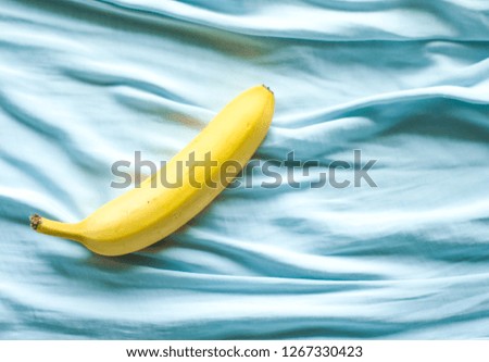 ripe banana on blue background - fresh fruits and healthy eating styled concept, elegant visuals