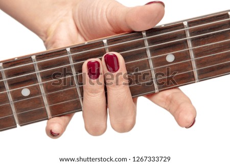 Girl playing an electric guitar on white background .