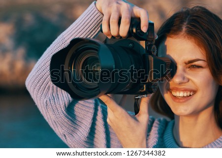 Cheerful female photographer in nature                    