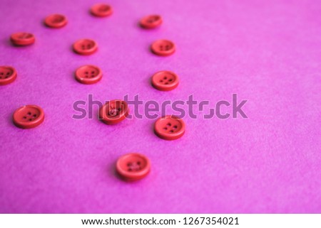 Beautiful texture with many round pink buttons for sewing, needlework. Copy space. Flat lay. Pink, purple background.