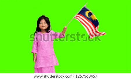 Beautiful Female Kid wearing national costume with Malaysia Flag. Green Screen.