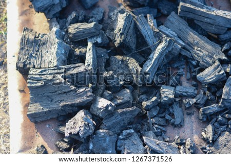 Black charcoal obtained from burning wood with high heat
