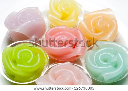 Candy colored roses on a white background.