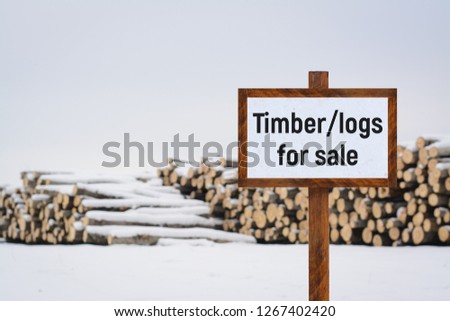 Sign TIMBER/LOGS FOR SALE. Materials for constructing wooden buildings