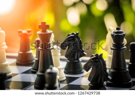 Black and White King and Knight of chess battle on board . Black king are leader to fight with teamwork to victory. Leader and teamwork concept for success. Competition and defeating concept