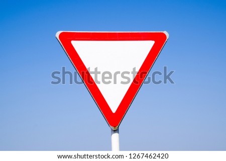 Road signs, give way. Sign on a blue background.