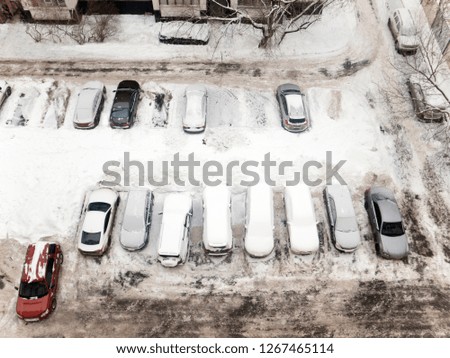 Overhead view of a car parking covered with snow
