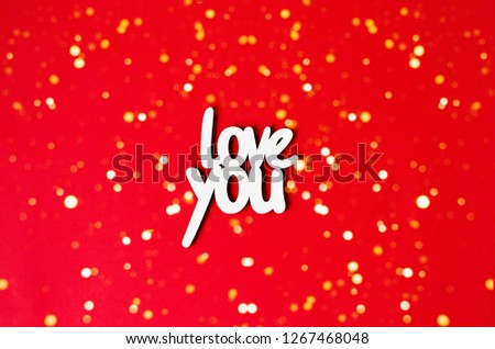 The word love you on a red background with lights.