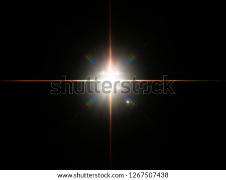 Headlight or camera flash on a dark reflective background reveals vivid colorful star burst. Royalty-Free Stock Photo #1267507438