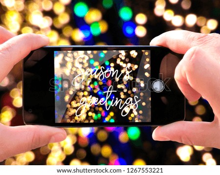 Concept of celebrating new year and christmas. The hands of men make a telephone photograph cozy mood winters. Greeting card. Photos for social networks, blogs, instagram.