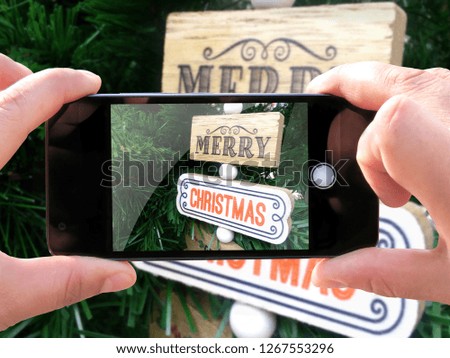 Concept of celebrating new year and christmas. The hands of men make a telephone photograph cozy mood winters. Greeting card. Photos for social networks, blogs, instagram.