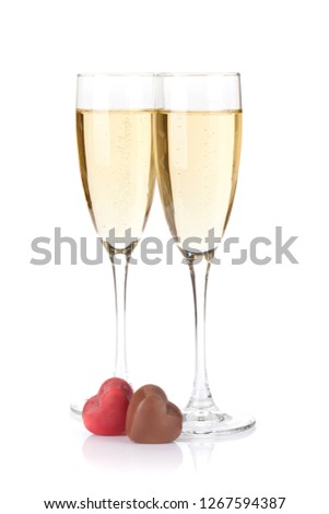 Valentines day chocolate hearts and champagne glasses. Isolated on white background
