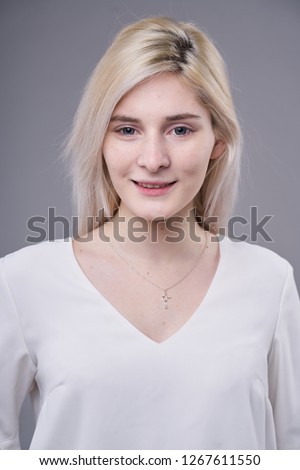 young beauty girl in white clothes on the gray backround            