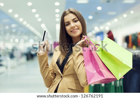 Young woman with credit card and shopping bags