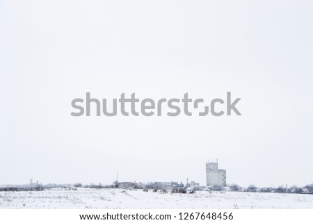 Snowcovered village street and field background landspace