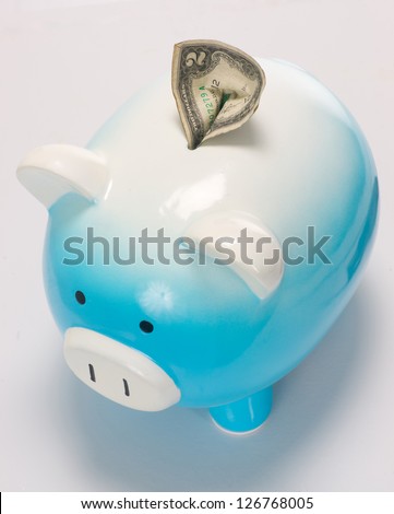 Two Dollar Bill Stuck in the Piggy Bank Save Money Savings Bank on white Savings Bank