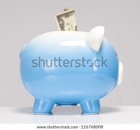 Save Money Two Dollar Bill Stuck in Savings Piggy Bank on white
