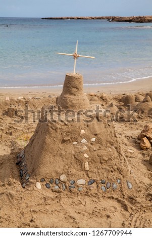 Big sand castle made by child in Cyprus. Sand castle by the sea.